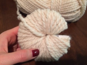 This finished pom-pom was wrapper 3 times. Now it looks like a fluffy donut!